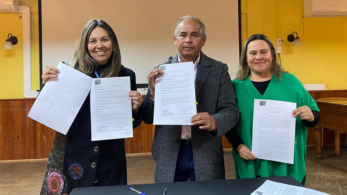 Personas mostrando documentos en sus manos.