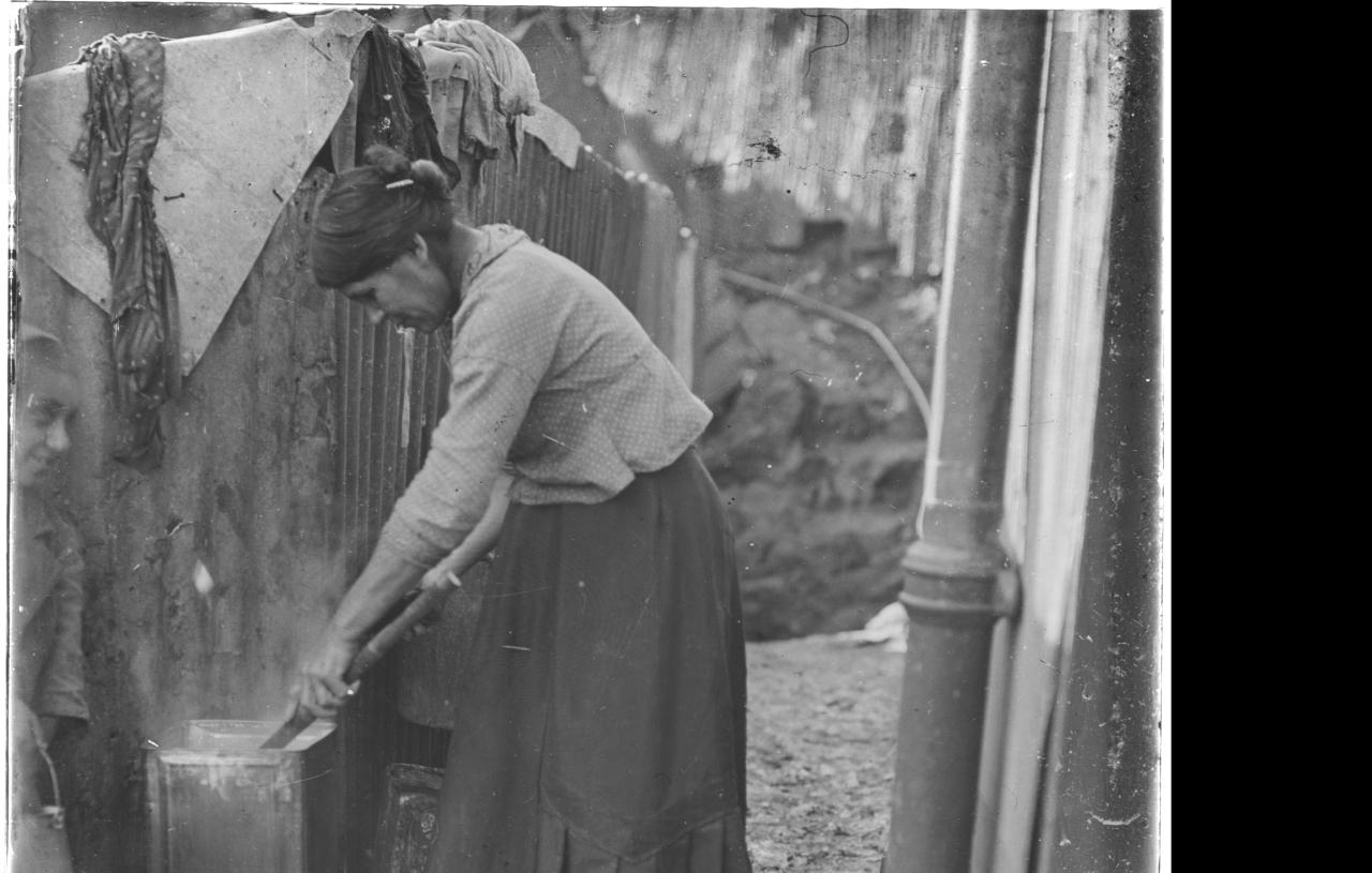 Mujer lavanso en una olla.